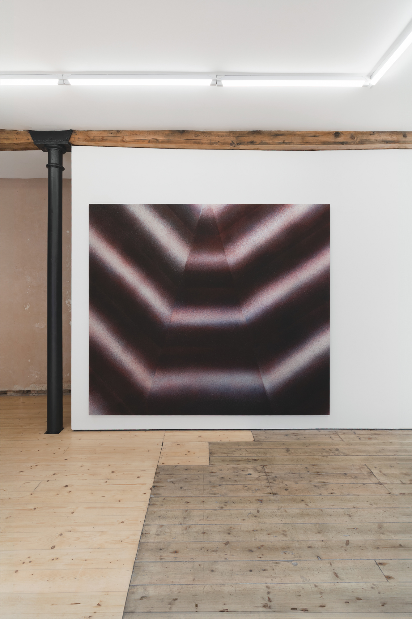An abstract painting sits on a white gallery wall, with a wooden floor in the foreground.