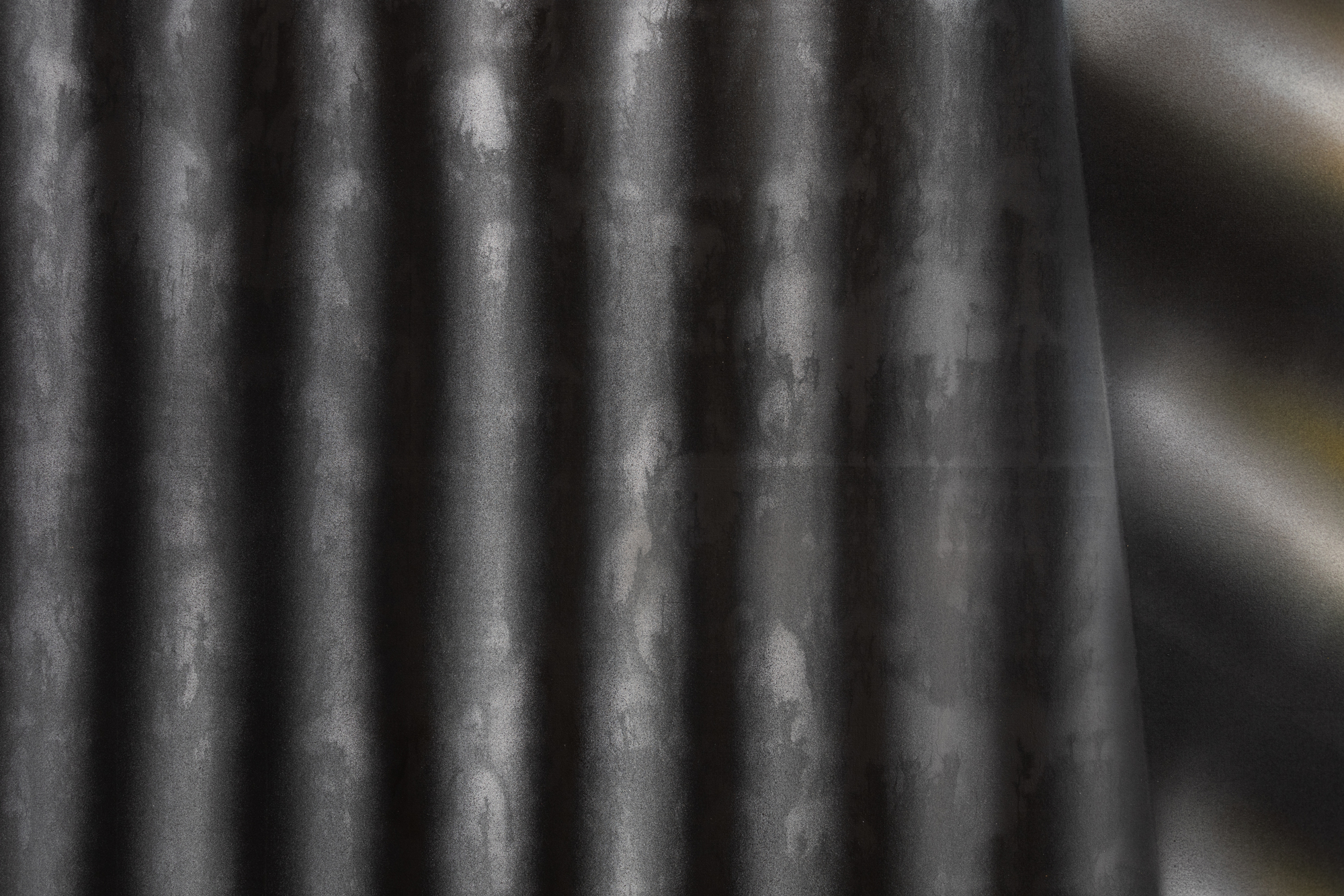 vertical stripes in black and white with a textured surface underneath.